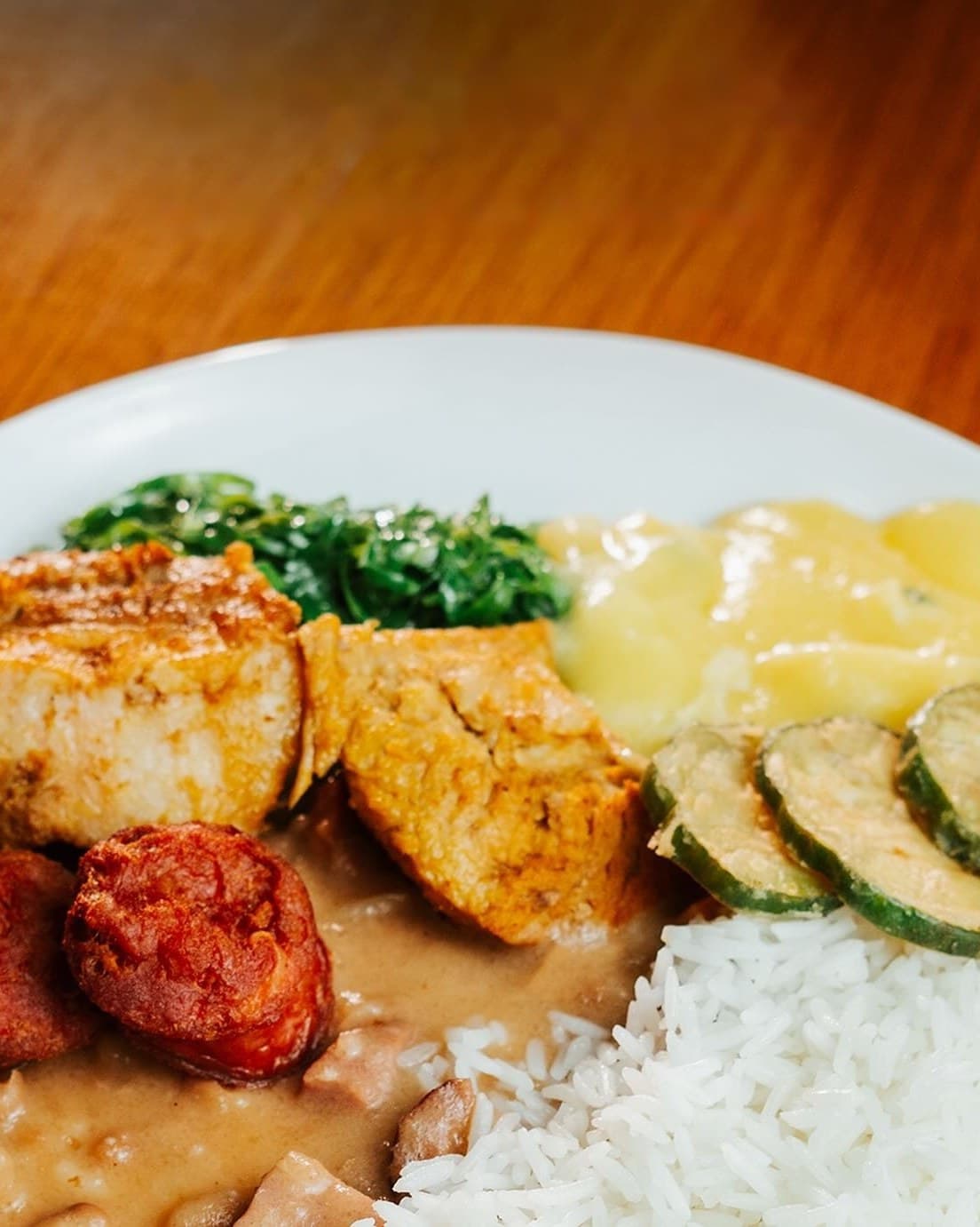 Prato com lombo, linguiça, tutu de feijão e arroz